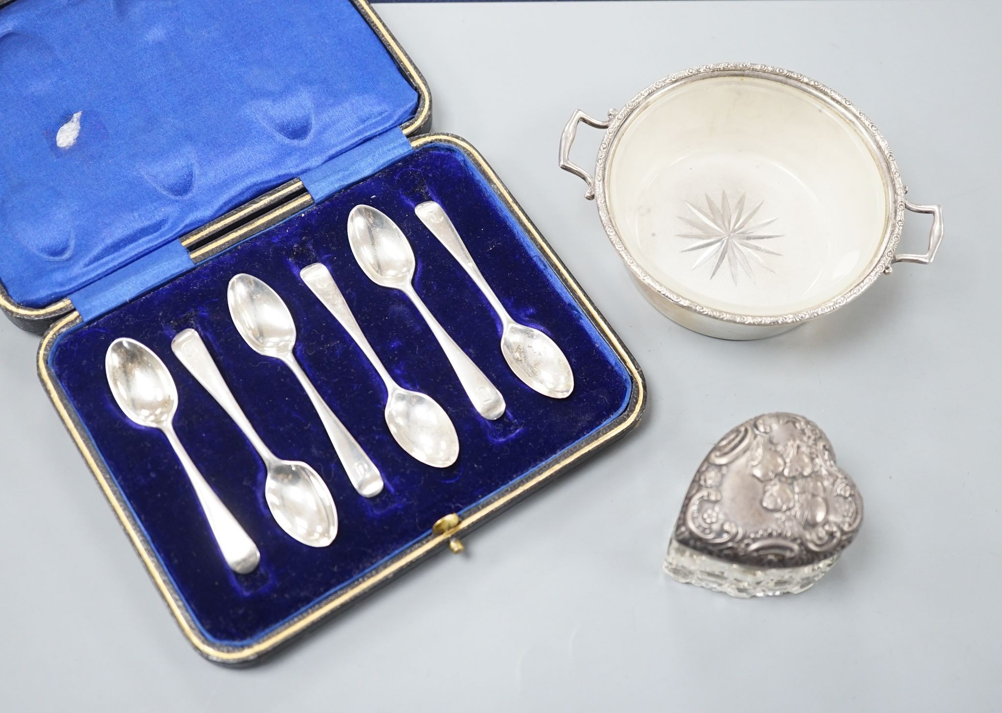 A set of six silver teaspoons, a silver two handled small butter dish, with glass liner and silver mounted cut glass toilet jar.